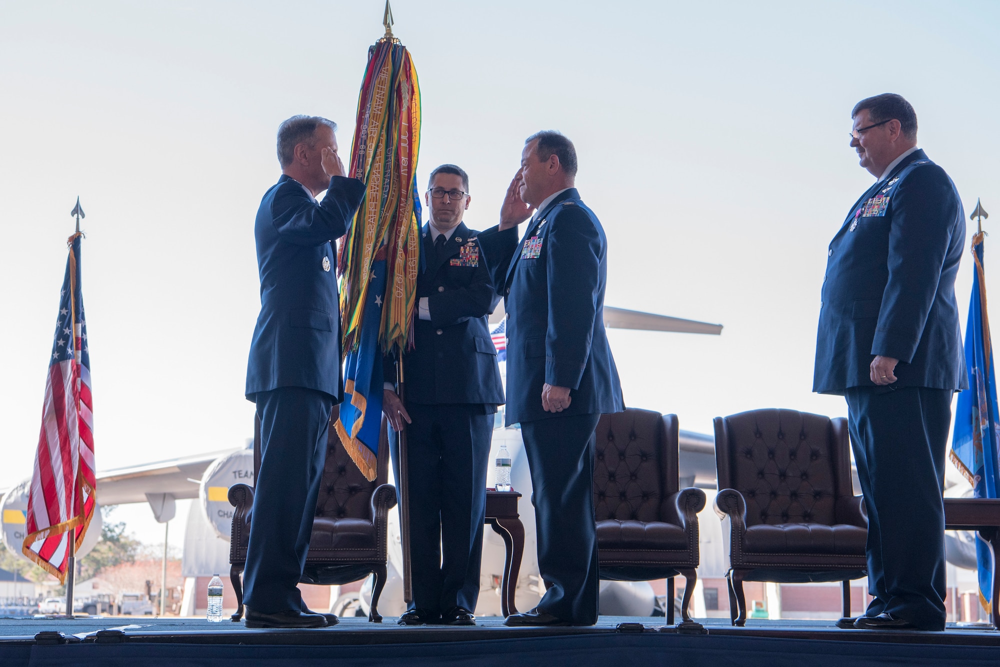 Col. Adam Willis, middle, incoming 315th Airlift Wing commander, takes command during a change of command ceremony officiated by Maj. Gen. Randall Ogden, left, U.S. Air Force 4th Air Force Commander, at Nose Dock 2 here, Dec. 7. Willis replaced Col. Gregory Gilmour, right, as the 315th Airlift Wing commander.