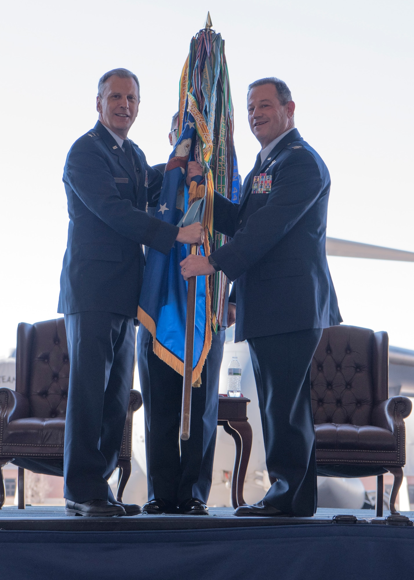 Col. Adam Willis, right, incoming 315th Airlift Wing commander, takes command during a change of command ceremony officiated by Maj. Gen. Randall Ogden, left, U.S. Air Force 4th Air Force Commander, at Nose Dock 2 here, Dec. 7. Willis replaced Col. Gregory Gilmour, right, as the 315th Airlift Wing commander.