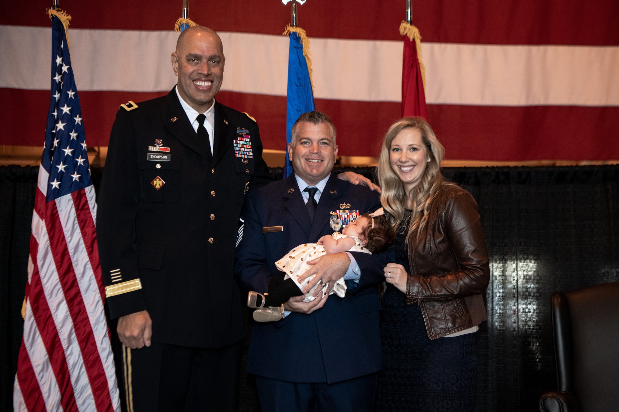 Master Sgt. Bryan Whittle, with the 205th Engineering and Installation Squadron, poses with Maj. Gen. Michael C. Thompson, adjutant general for Oklahoma, and his wife Shannon Whittle, after receiving the Airman’s Medal in a ceremony at Will Rogers Air National Guard Base in Oklahoma City, Dec. 8, 2019. The Airman’s Medal is the highest noncombat award given in the Air Force and awarded to service members who distinguish themselves by a heroic act, usually at the voluntary risk of their own life. (U.S. Air National Guard photo by Staff Sgt. Jordan Martin)