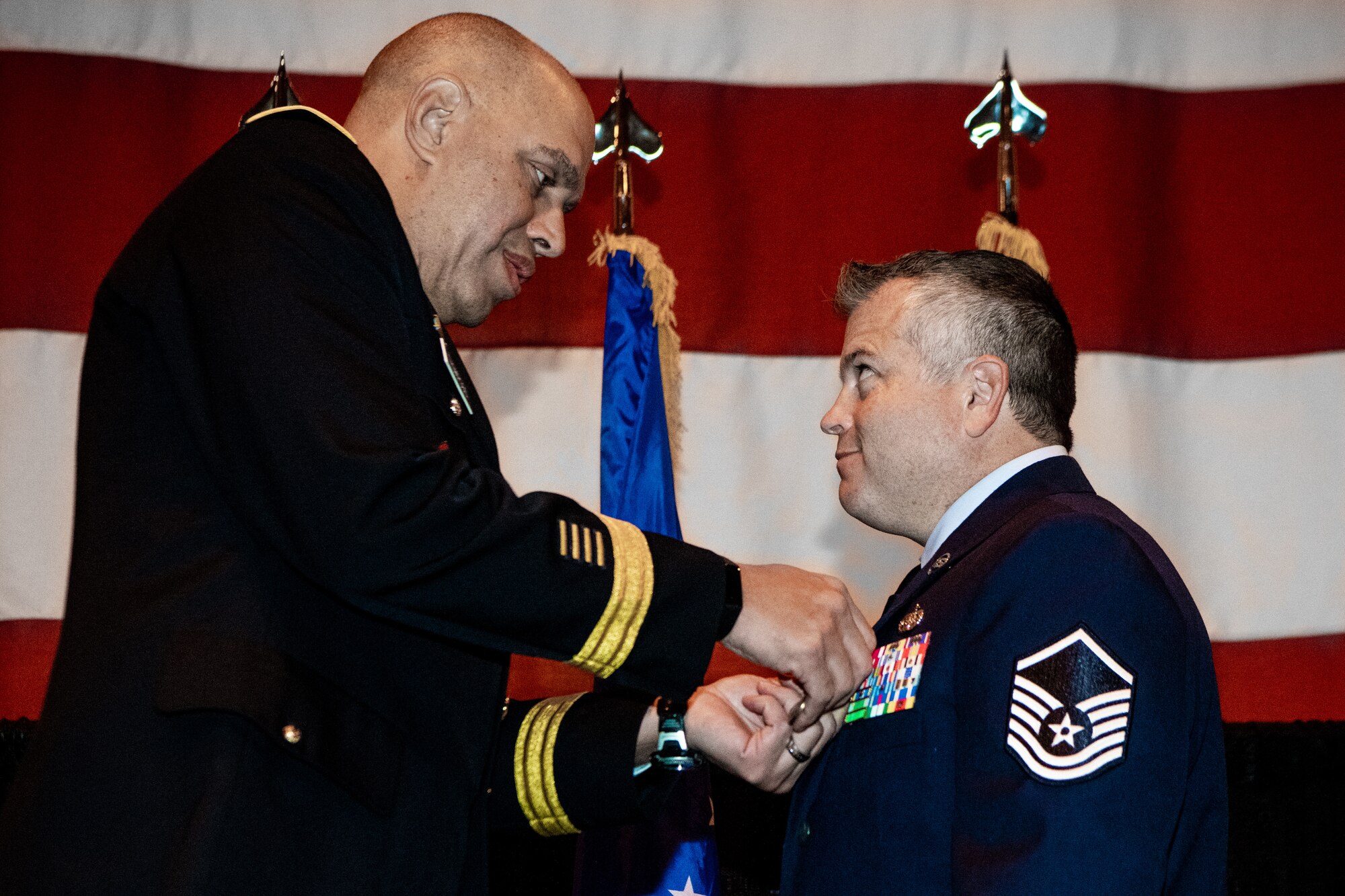 Maj. Gen. Michael C. Thompson, adjutant general for Oklahoma, presents Master Sgt. Bryan Whittle, assigned to the 205th Engineering and Installation Squadron, with the Airman’s Medal at an award ceremony at Will Rogers Air National Guard Base in Oklahoma City, Dec. 8, 2019. The Airman’s Medal is the highest noncombat award given in the Air Force and awarded to service members who distinguish themselves by a heroic act, usually at the voluntary risk of their own life.  (U.S. Air National Guard photo by Staff Sgt. Jordan Martin)
