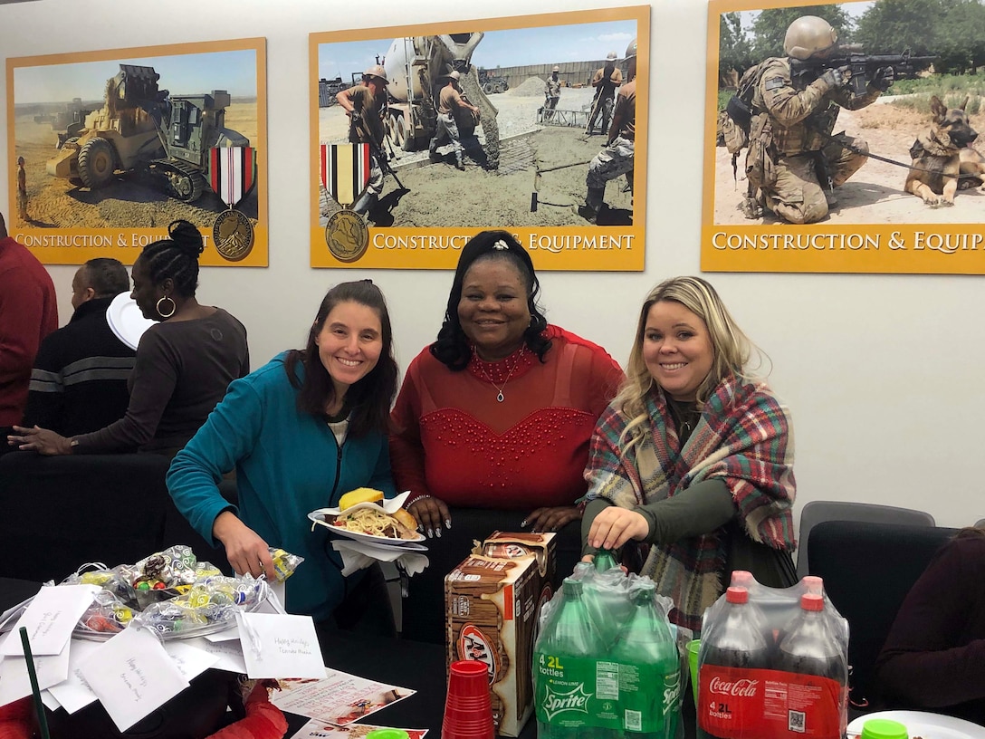 Marsha Brenner, left, contract specialist, Cynthia Mitchell-Riley, center, commodity support liaison, and Kelsie Schoen, right, material planner, with the Construction and Equipment supply chain enjoy the Culture Improvement Team’s holiday lunch. The event was held at the Defense Logistics Agency Troop Support Headquarters in Philadelphia on Dec. 5, 2019.