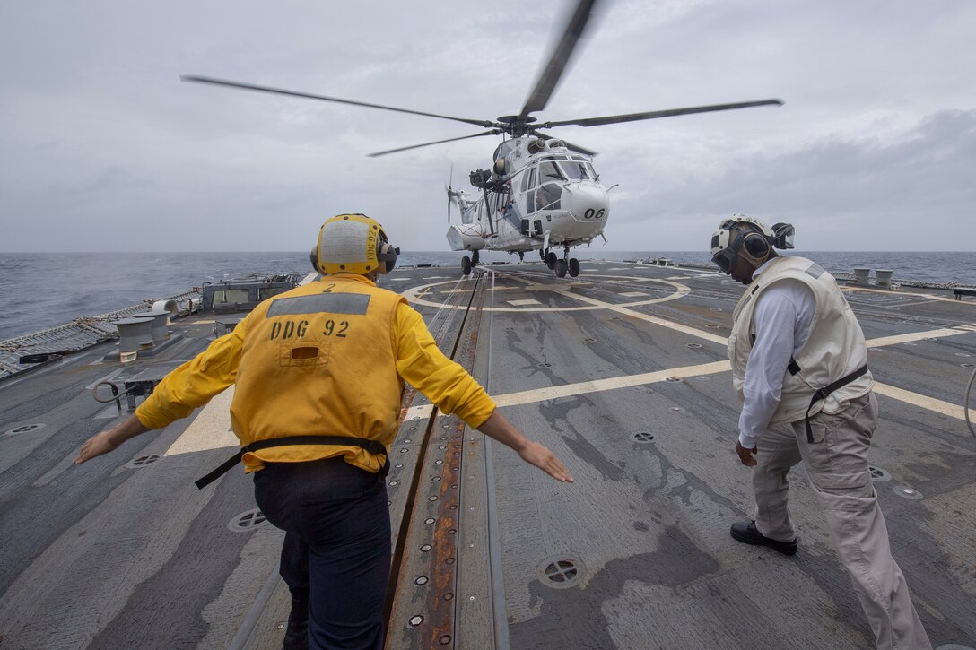 Helicopter takes off from a ship.