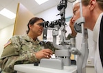 Col. Adrienne Ari, an optometrist at Landstuhl Regional Medical Center in Germany, performs an eye examination Sept. 19, 2019. In October 2018, the Army, Navy and Air Force started the process to transfer the administration and management of their military medical treatment facilities to DHA. Phase II of that transition was completed this fall with roughly half of the MTFs in the continental U.S. now under the DHA. All other hospitals and clinics, including those overseas, will follow suit by 2021.