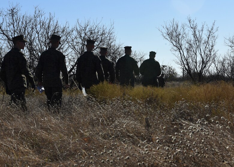 U.S. Marine Corps Detachment students trek into the field behind the flight line for a field-oriented data collection exercise on Goodfellow Air Force Base, Texas, Dec. 6, 2019. The students worked together to pinpoint where radio frequency transmissions came from to track counter intelligence during the exercise. (U.S. Air Force Photo by Airman 1st Class Abbey Rieves)