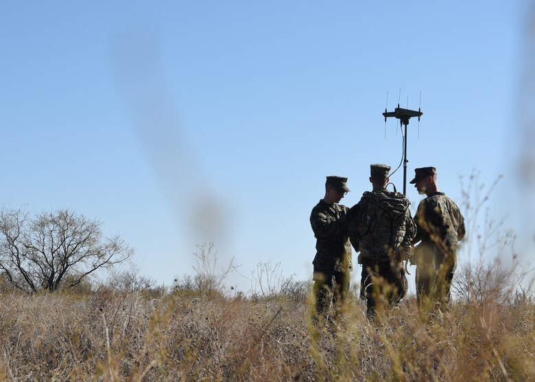 U.S. Marine Corps Detachment students compare radio location indicators with a paper map to confirm the location of an adversary during an intelligence field exercise on Goodfellow Air Force Base, Texas, Dec. 6, 2019.  The students confirmed that the adversary’s location was close by. (U.S. Air Force Photo by Airman 1st Class Abbey Rieves)