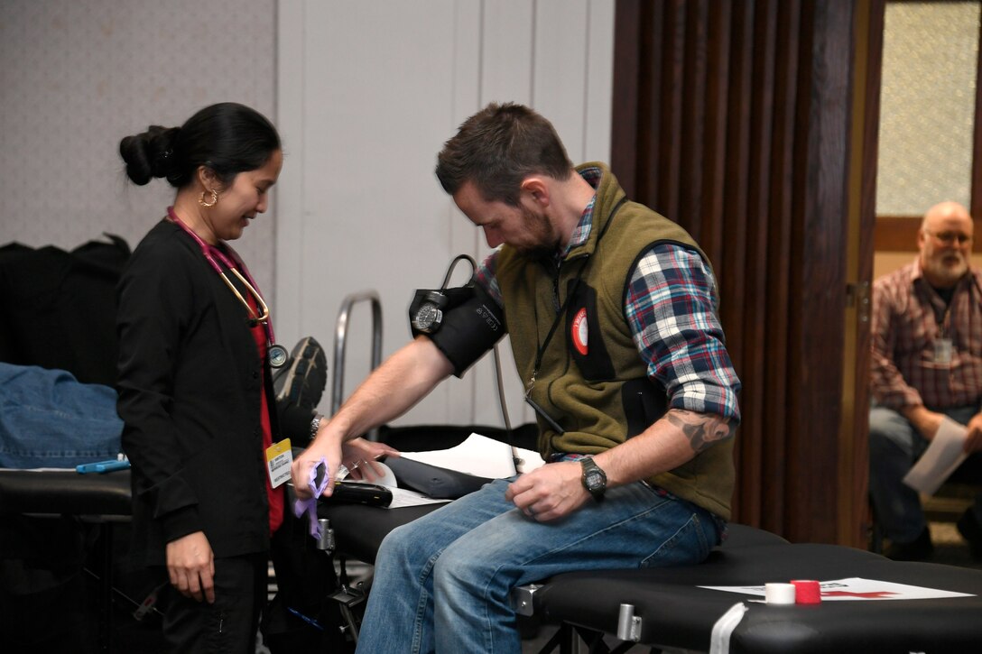 An employee has his blood pressure checked while participating in the Dec. 4 American Red Cross blood drive at the Hart-Dole-Inouye Federal Center.