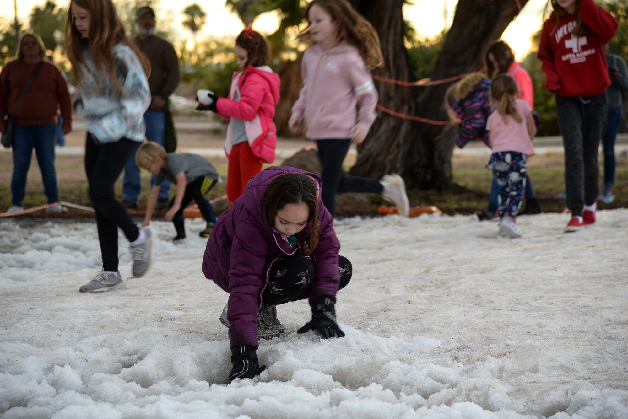 a photo of Kids playing in the snow during a base holiday event.