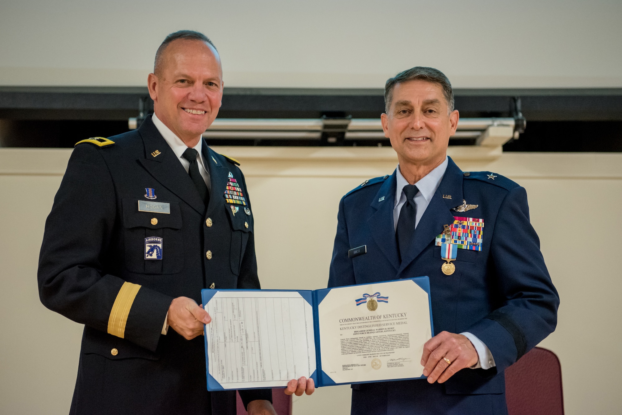 Brig. Gen. Warren Hurst (right), Kentucky’s outgoing assistant adjutant general for Air, receives the Kentucky Distinguished Service Medal from Army Maj. Gen. Stephen Hogan, Kentucky’s adjutant general, during Hurst’s retirement ceremony at the Kentucky Air National Guard Base in Louisville, Ky., Nov. 16, 2019. Hurst is retiring after more than 34 years of service to the active-duty Air Force and Kentucky Air National Guard. (U.S. Air National Guard photo by Staff Sgt. Joshua Horton)