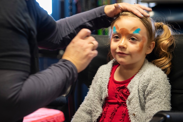 Kara, 5, gets her face painted at the annual Children’s Holiday Fest at Schriever Air Force Base, Colorado, Dec. 7, 2019. The annual event is free and open to all of Team Schriever and their families. (U.S. Air Force photo by Airman 1st Class Jonathan Whitely)