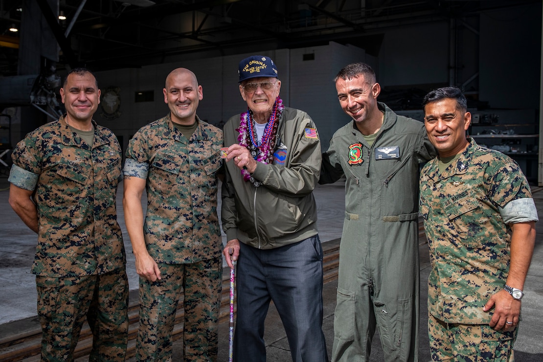 Donald Long, retired U.S. Navy radio operator, and U.S. Marines pose for a group photo during his visit, Marine Corps Base Hawaii, Dec. 5, 2019. The Best Defense Foundation returned 6 WWII Pearl Harbor and Naval Air Station Kaneohe Bay survivors to Hawaii for the 78th Commemoration of Pearl Harbor and Naval Air Station Kaneohe Bay which is now MCBH. The heroes returned were Jack Holder US NAVY - Naval Air Station, Kaneohe Bay; Tom Foreman US Navy - USS Cushing; Ira Schab US Navy - USS Dobbin; Stuart Hedley US Navy - USS West Virginia; Donald Long US Navy - Naval Air Station, Kaneohe Bay; and Chuck Kohler US Navy - USS Hornet.