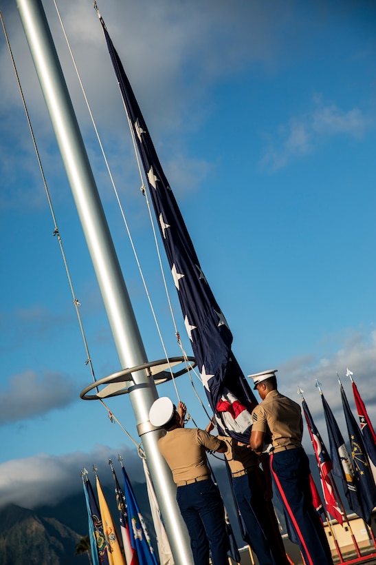 U.S. Marines with the Headquarters Battalion color guard hoist the colors during the annual Klipper Ceremony, Marine Corps Base Hawaii, Dec. 7, 2019. The Klipper Memorial was dedicated in 1981 to honor the 17 U.S. Navy Sailors and two civilian contractors who died during the attack on Naval Air Station Kaneohe Bay on Dec. 7, 1941.