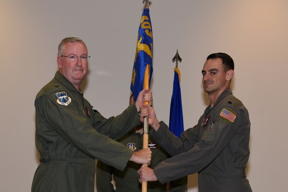 Col. Jeffrey A. Van Dootingh, left, 403rd Wing commander, passes the 403rd Operations Group guidon to Lt. Col. Stuart M. Rubio, right, during an Assumption of Command ceremony at Keesler Air Force Base, Mississippi, Dec. 7, 2019. The 403rd Operations Group commander is responsible for the readiness and effectiveness of the 5th and 12th Operational Weather Flights, 36th Aeromedical Evacuation Squadron, the 53rd Weather Reconnaissance Squadron, and the 815th Airlift Squadron. (U.S. Air Force photo by Tech. Sgt. Michael Farrar)