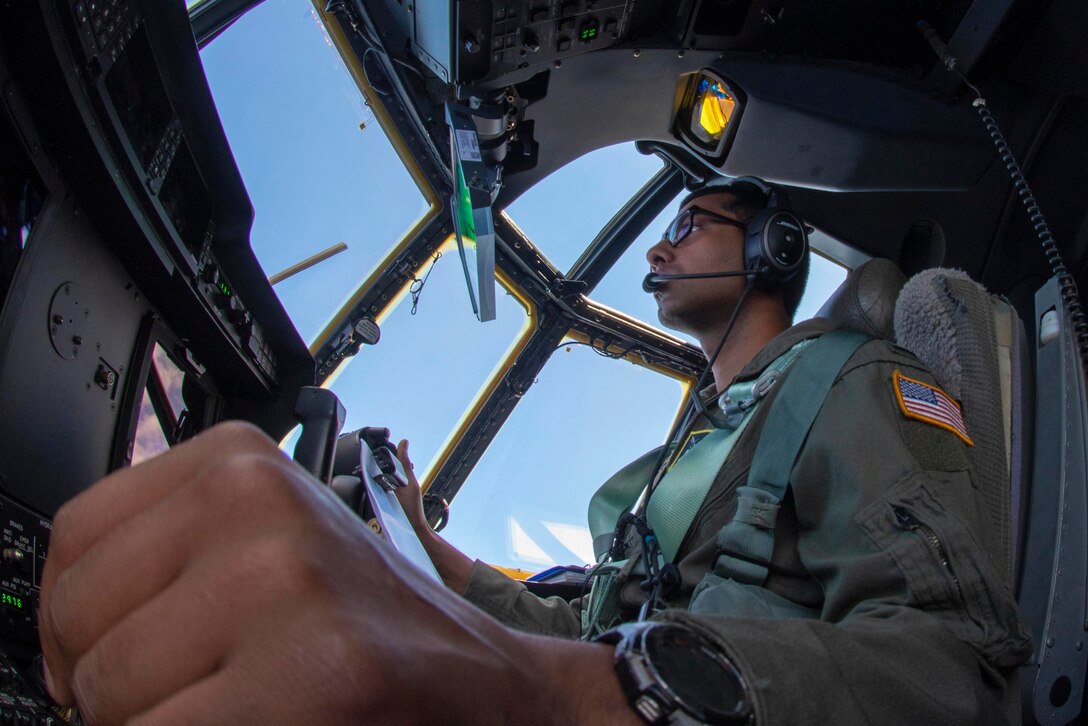 An airman sits in the cockpit of an aircraft.