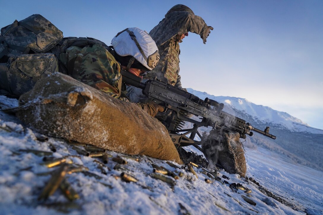 A soldier fires a weapon from the ground.