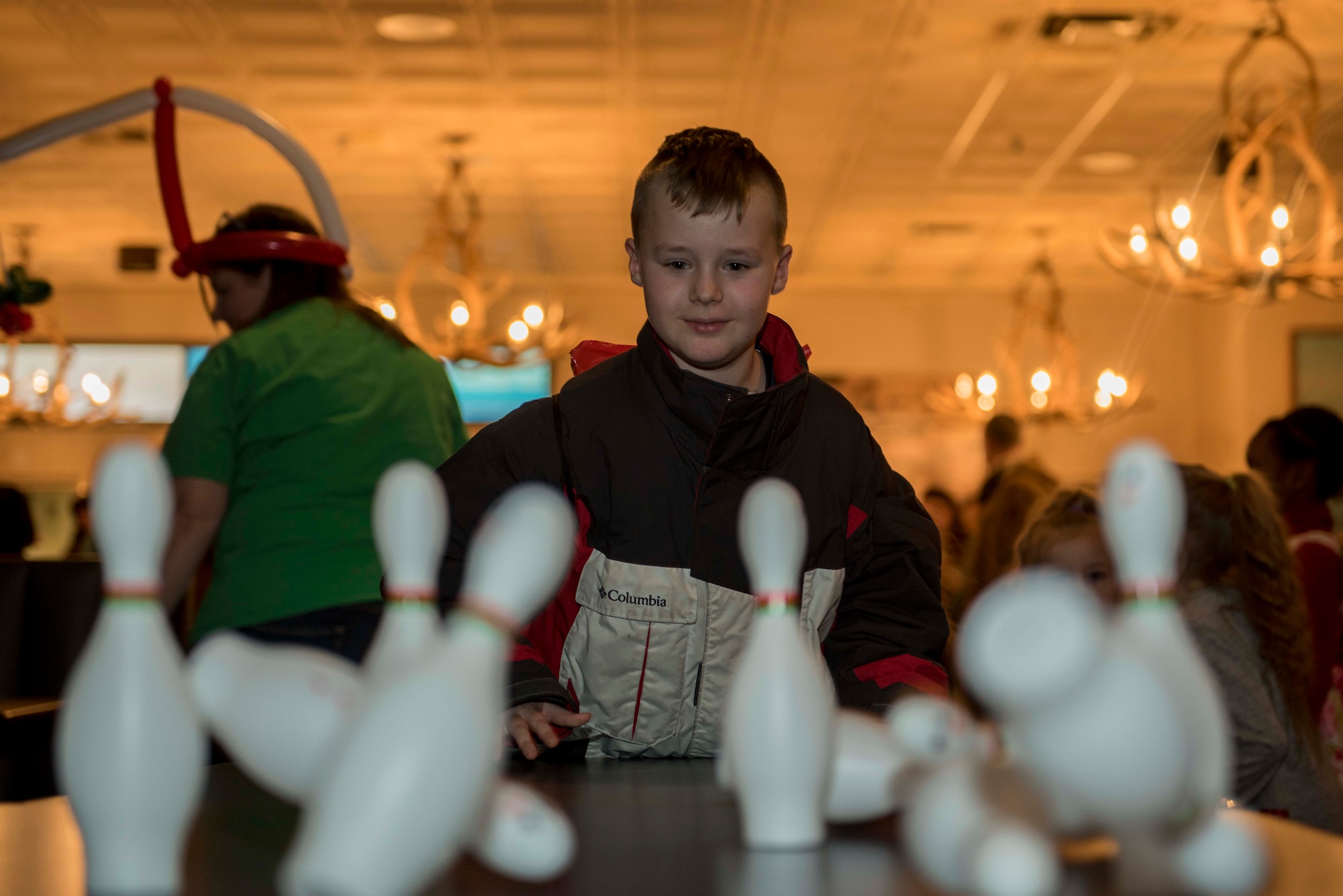 A 354th Fighter Wing family member bowls during Eielson’s Winter Festival at the Yukon Club on Eielson Air Force Base, Alaska, Dec. 6, 2019. Children participated in games at the free event in order to win prizes. (U.S. Air Force photo by Airman 1st Class Aaron Larue Guerrisky)