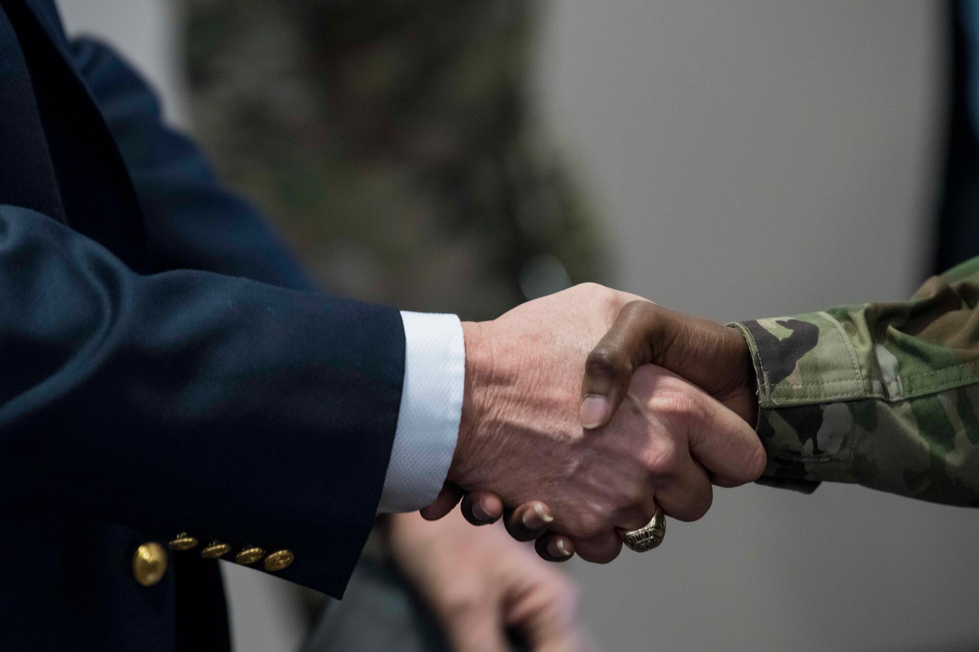 Retired Chief Master Sgt. of the Air Force Eric W. Benken shakes hands with Senior Master Sgt. Mary Lou Merrils, 27th Special Operations Logistics Readiness Squadron flight superintendent, at Cannon Air Force Base, N.M., Dec. 5, 2019. The 12th and 13th Chief Master Sgts. of the Air Force visited Cannon to share their stories with Air Commandos.  (U.S. Air Force photo Senior Airman Vernon R. Walter)