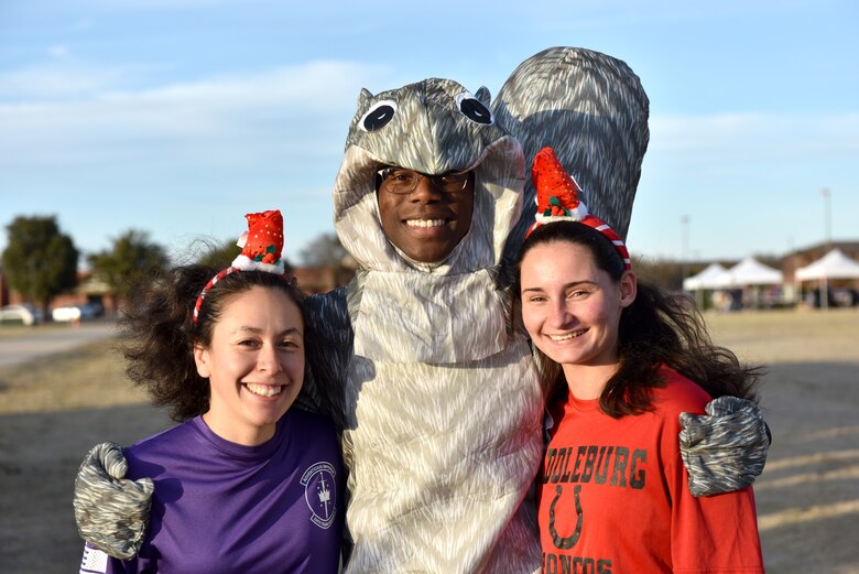 Airman 1st Class Allissa Castro, Airman 1st Class Mitchell Dieudonne and Airman Autumn Ross, 315th Training Squadron students, pose for a picture at the Jingle Bell 5K before the Tree Lighting ceremony on the parade field at Goodfellow Air Force Base, Texas, Dec. 6, 2019. Participants in the run were given festive headbands and encouraged to dress up to show their morale. (U.S. Air Force photo by Senior Airman Seraiah Wolf)