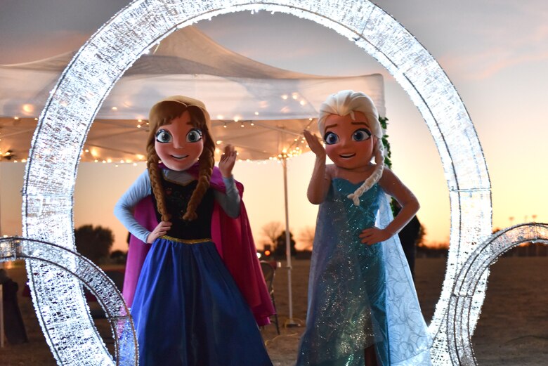 Individuals dressed as Anna and Elsa were available for pictures at the Tree Lighting event on the parade field at Goodfellow Air Force Base, Texas, Dec. 6, 2019. Santa also arrived to the parade field allowing attendees to tell him what they wanted for Christmas. (U.S. Air Force photo by Senior Airman Seraiah Wolf)