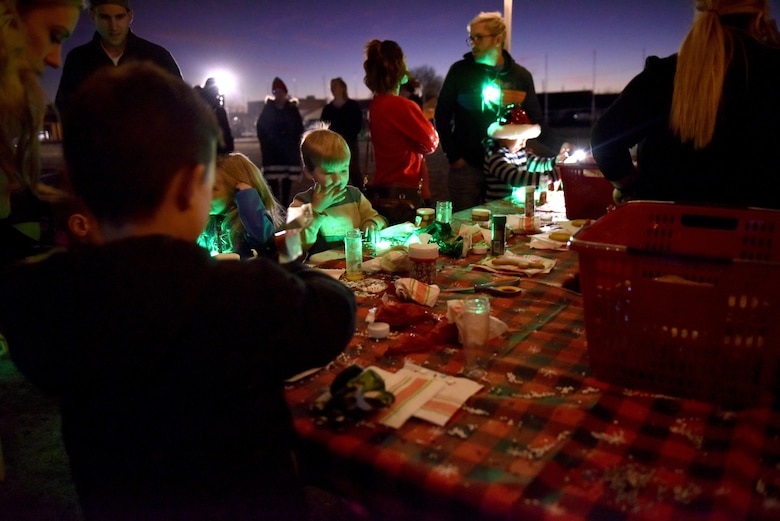 Children decorate cookies at the Tree Lighting event on the parade field at Goodfellow Air Force Base, Texas, Dec. 6, 2019. Attendees could decorate cookies to take home or eat at the event. (U.S. Air Force photo by Senior Airman Seraiah Wolf)
