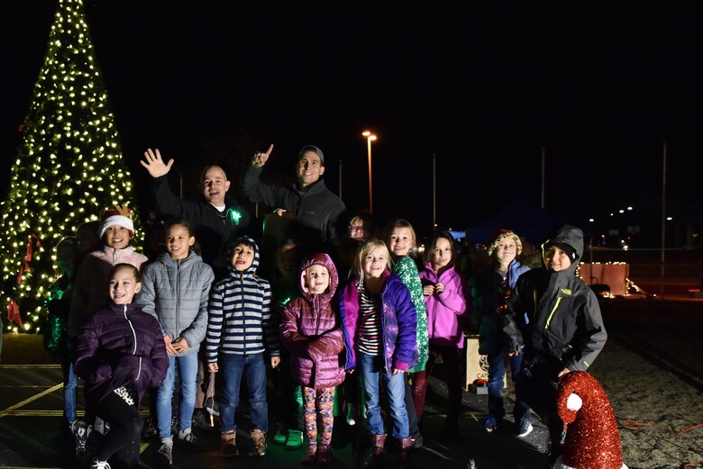 Col. Andres Nazario, 17th Training Wing commander, announces the winner of the Christmas card contest with the help of children attending the Tree Lighting ceremony on Goodfellow Air Force Base, Texas, Dec. 6, 2019. The Christmas Cards contest builds camaraderie and connectedness within the squadrons, the 312th Training Squadron took 1st place this year. (U.S. Air Force photo by Senior Airman Seraiah Wolf)