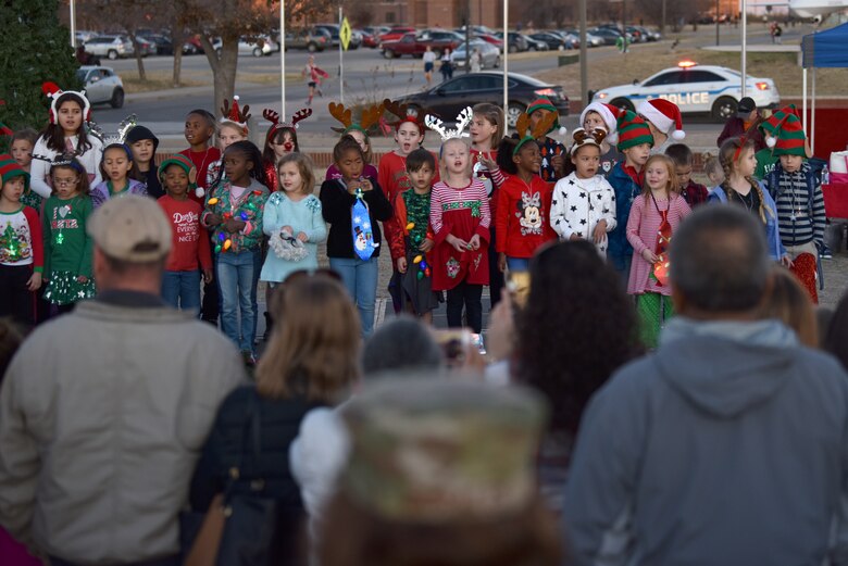 Children sing carols during the Tree Lighting ceremony at the parade field on Goodfellow Air Force Base, Texas, Dec. 6, 2019. There were also several dances performed by other children. (U.S. Air Force photo by Senior Airman Seraiah Wolf)