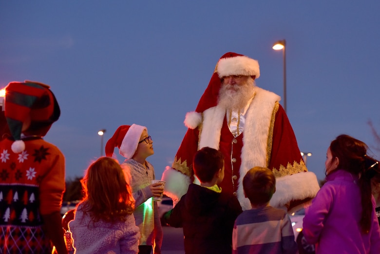 Santa talks with children after arriving to the parade field for the Tree Lighting ceremony on Goodfellow Air Force Base, Texas, Dec. 6, 2019. Children were able to tell Santa what they wanted for Christmas and have their picture taken before the tree lighting. (U.S. Air Force photo by Senior Airman Seraiah Wolf)