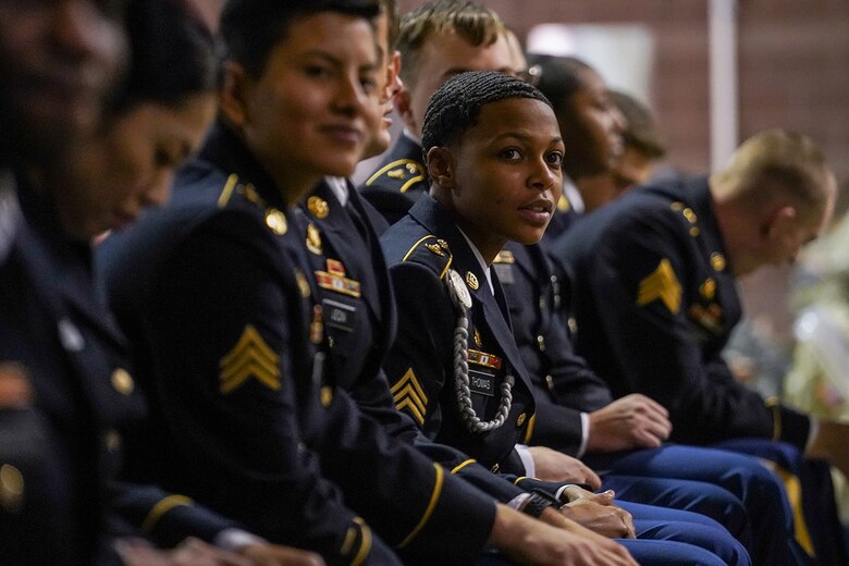 Army Sgt. Nevia Thomas, assigned to the 539th Composite Truck Company (Light), 17th Combat Sustainment Support Battalion, U.S. Army Alaska, sits with fellow newly-minted noncommissioned officers during an NCO induction ceremony at the Alaska Army National Guard armory on Joint Base Elmendorf-Richardson, Alaska, Dec. 6, 2019, as the group makes the career transition to junior leaders, and are promoted to the rank of sergeant. When Army Soldiers are promoted to the noncommissioned officer ranks they become the first level of authority in their Soldiers' chains of command, and are responsible for their charges' health, welfare, training and discipline.