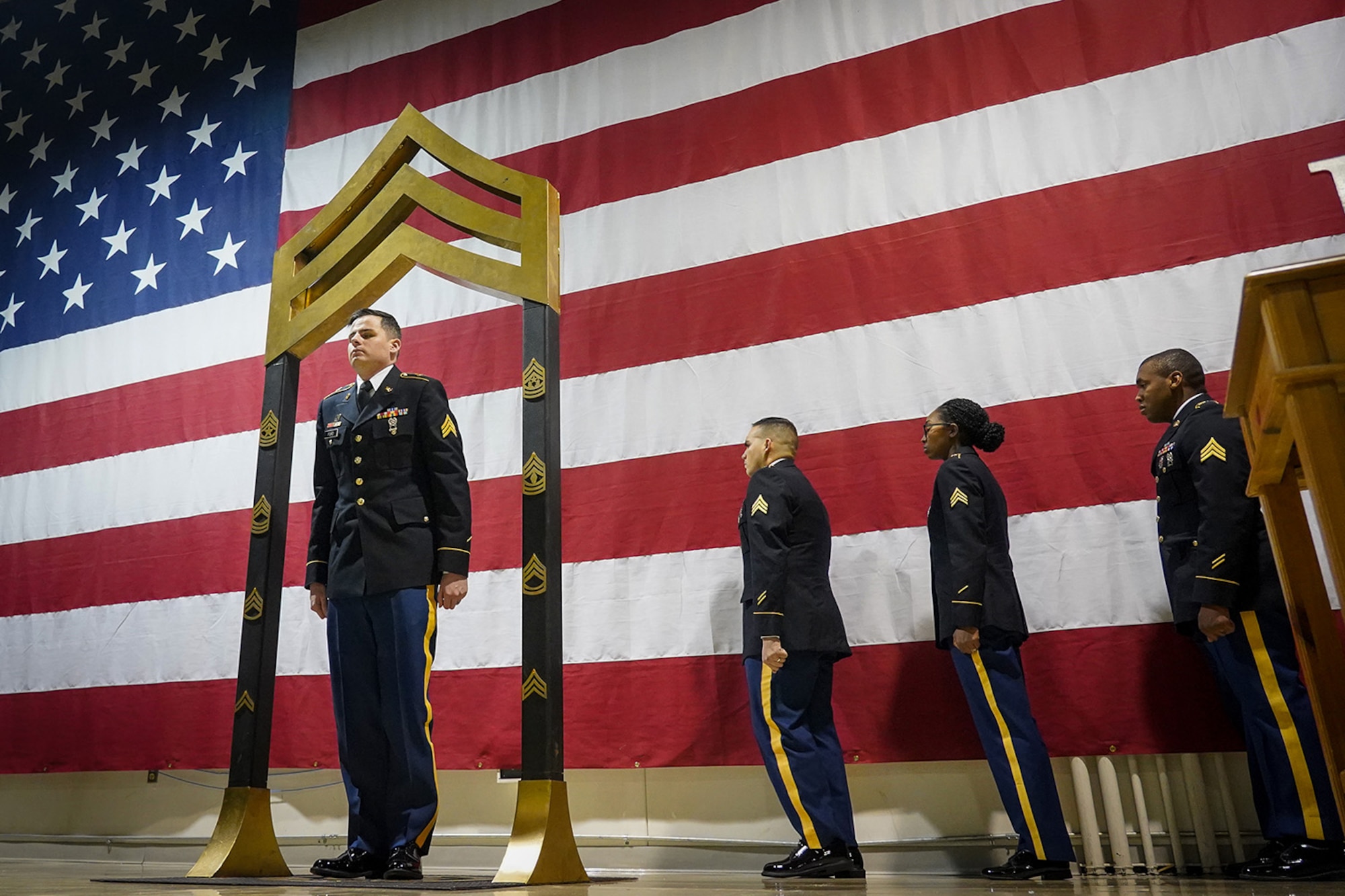 Army Sgt. Corey Ford, assigned to the 95th Chemical Company, 17th Combat Sustainment Support Battalion, U.S. Army Alaska, participates in a Noncommissioned Officer induction ceremony at the Alaska Army National Guard armory on Joint Base Elmendorf-Richardson, Alaska, Dec. 6, 2019, as he makes the career transition into junior leader, and is promoted to the rank of sergeant. When Army Soldiers are promoted to the noncommissioned officer ranks they become the first level of authority in their Soldiers' chains of command, and are responsible for their charges' health, welfare, training and discipline.