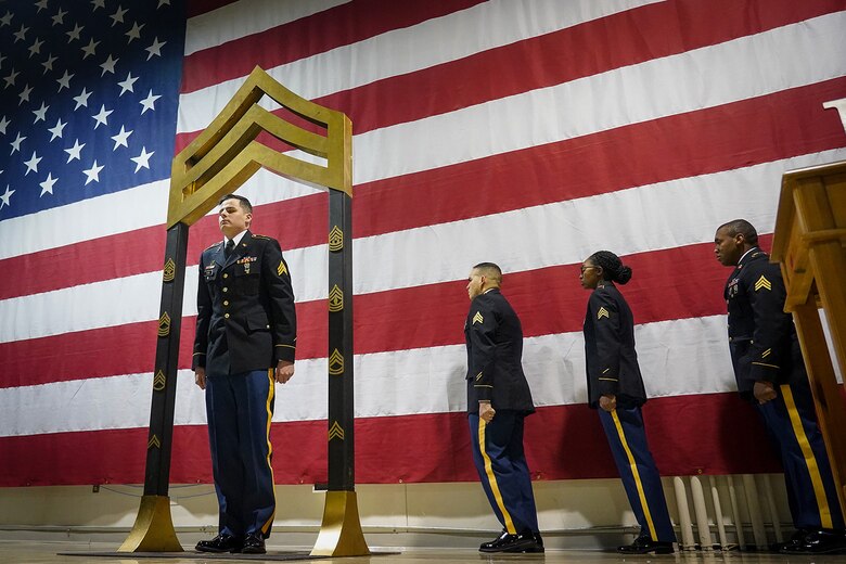 Army Sgt. Corey Ford, assigned to the 95th Chemical Company, 17th Combat Sustainment Support Battalion, U.S. Army Alaska, participates in a Noncommissioned Officer induction ceremony at the Alaska Army National Guard armory on Joint Base Elmendorf-Richardson, Alaska, Dec. 6, 2019, as he makes the career transition into junior leader, and is promoted to the rank of sergeant. When Army Soldiers are promoted to the noncommissioned officer ranks they become the first level of authority in their Soldiers' chains of command, and are responsible for their charges' health, welfare, training and discipline.