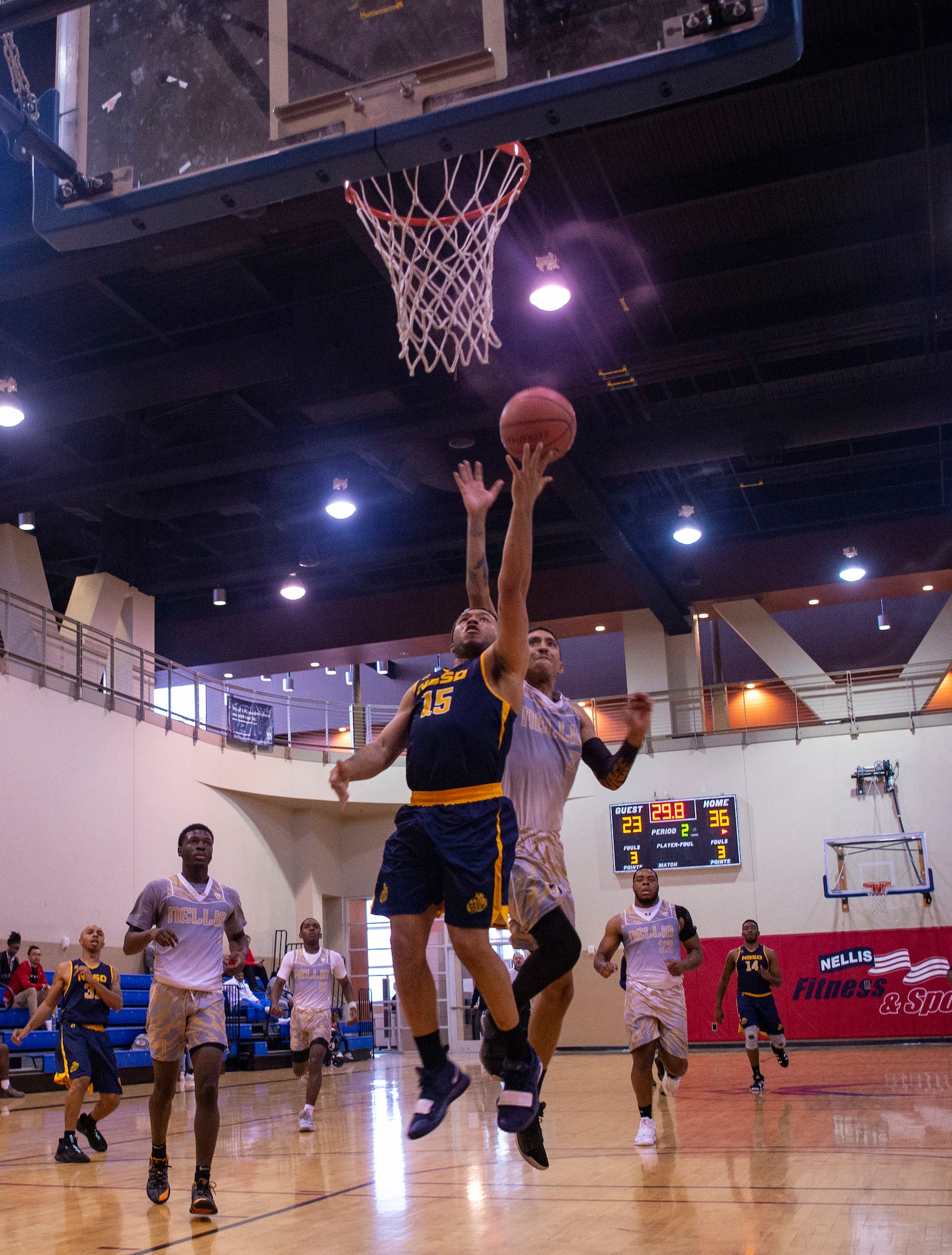 Naval Base San Diego Tritons basketball player goes for a layup