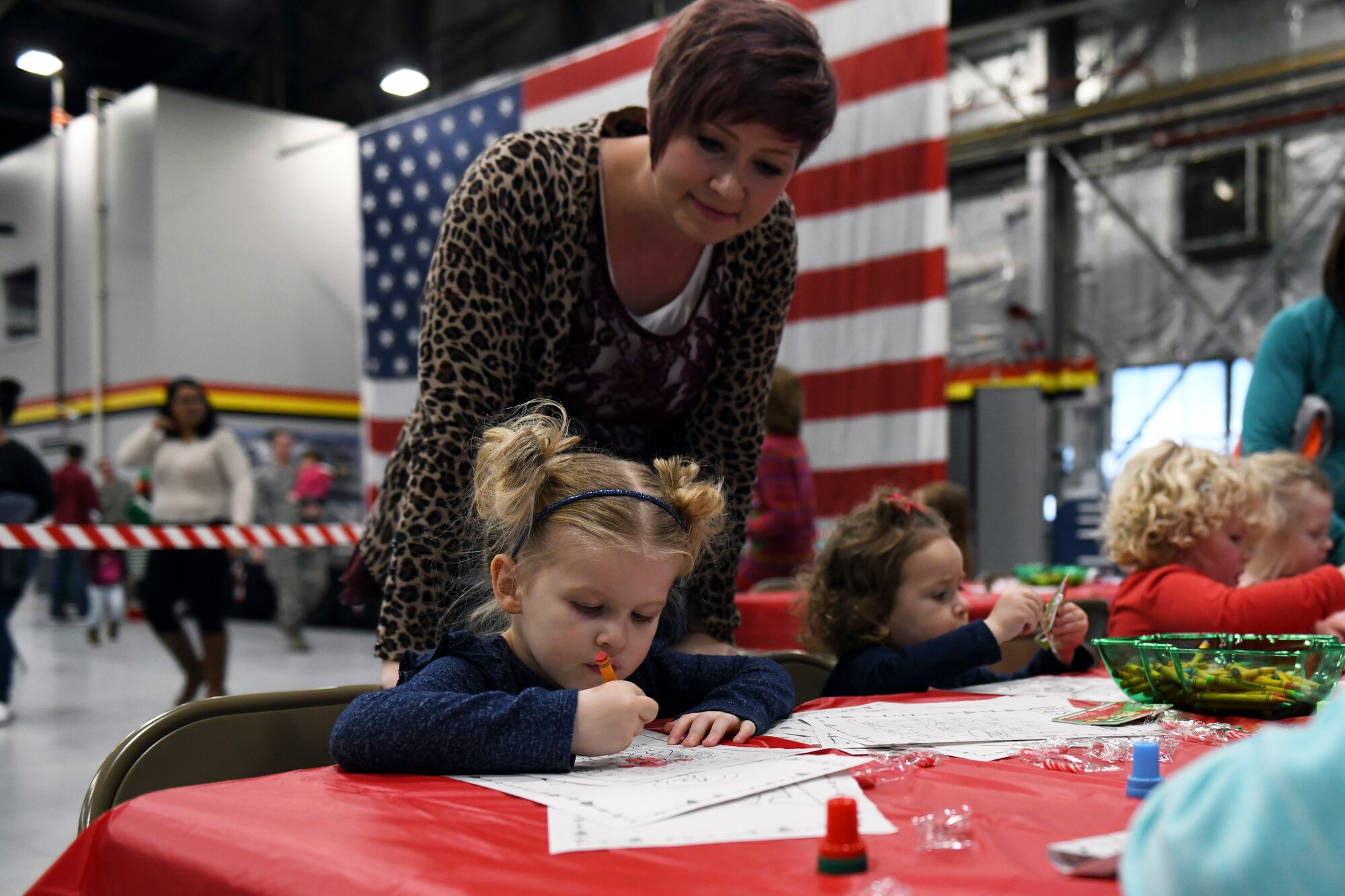 Candi Kimber, spouse of a 419th Fighter Wing reservist, watches over her daughter, Cambrie, as she colors at the Children’s Christmas Party Dec. 8 at Hill Air Force Base, Utah