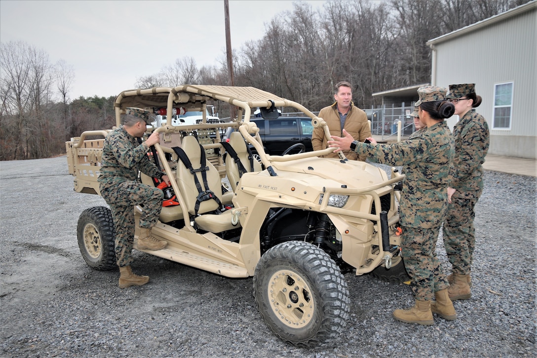 Jason Engstrom, center, a Utility Task Vehicle engineer with Program Executive Officer Land Systems, reviews several of the vehicles upgrades with Marines at the Transportation Demonstration Support Area aboard Marine Corps Base Quantico, Virginia, Dec. 4, 2019. PEO Land System’s Light Tactical Vehicle program office is currently implementing several upgrades—including an environmental protection cover, upgraded tires and clutch improvement kit—to UTVs across the fleet. (U.S. Marine Corps photo by Ashley Calingo)