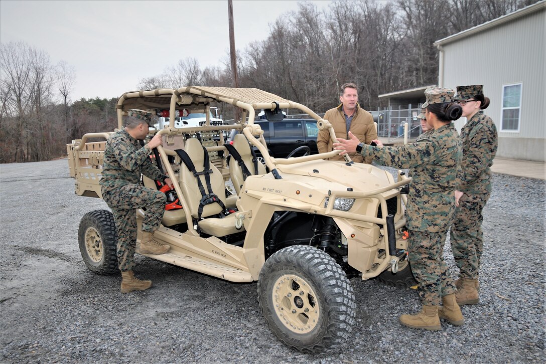 Jason Engstrom, center, a Utility Task Vehicle engineer with Program Executive Officer Land Systems, reviews several of the vehicles upgrades with Marines at the Transportation Demonstration Support Area aboard Marine Corps Base Quantico, Virginia, Dec. 4, 2019. PEO Land System’s Light Tactical Vehicle program office is currently implementing several upgrades—including an environmental protection cover, upgraded tires and clutch improvement kit—to UTVs across the fleet. (U.S. Marine Corps photo by Ashley Calingo)