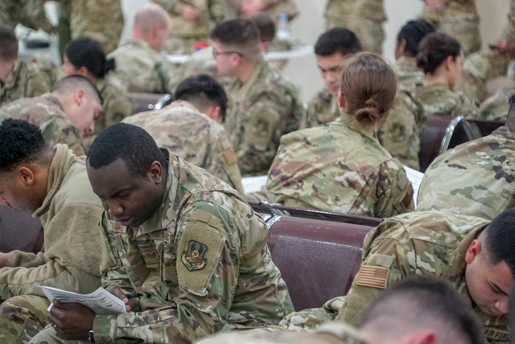 U.S. Air Force Tech. Sgt Michael Charles, left, a photographer from the 4th Fighter Wing Public Affairs, fills out paperwork after arriving on Prince Sultan Air Base (PSAB), Saudi Arabia, Nov. 26, 2019.