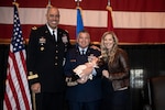 Master Sgt. Bryan Whittle, with the 205th Engineering and Installation Squadron, with his wife, Shannon Whittle, and Maj. Gen. Michael C. Thompson, adjutant general for Oklahoma, after receiving the Airman’s Medal in a ceremony at Will Rogers Air National Guard Base in Oklahoma City, Dec. 8, 2019. The Airman’s Medal is the highest noncombat award given in the Air Force and awarded to service members who distinguish themselves by a heroic act, usually at the voluntary risk of their own life.