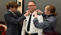 U.S. Military Academy Cadet Lauren Karbler and Tim Karbler place three stars on their newly promoted father’s, Lt. Gen. Daniel L. Karbler, Army Service Uniform during a ceremony at the U.S. Army Space and Missile Defense Command’s Redstone Arsenal, Alabama, headquarters Dec. 6. Karbler assumed command of USASMDC and Joint Functional Component Command for Integrated Missile Defense following his promotion. (Army photo by Jason B. Cutshaw)