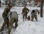 New York Army National Guard Soldiers assigned to the 3rd Battalion, 142nd Aviation, clear snow from a fire hydrant in Kinderhook, N.Y., Dec. 3, 2019.