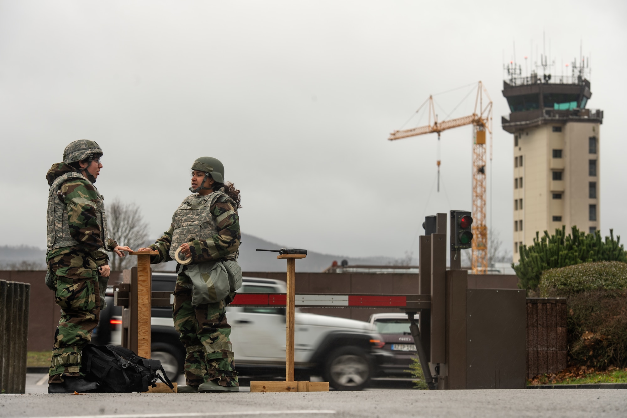 U.S. Air Force Airman 1st Class Jennifer Gonzales, left, and Staff Sgt. Nesha Stanton, 86th Airlift Wing Public Affairs photojournalists, set up stanchions during exercise Operation Varsity 19-04 at Ramstein Air Base, Germany, Dec. 9, 2019. The stanchions contain simulated M8 paper which detect airborne chemicals present in the area. (U.S. Air Force photo by Staff Sgt. Devin Boyer)