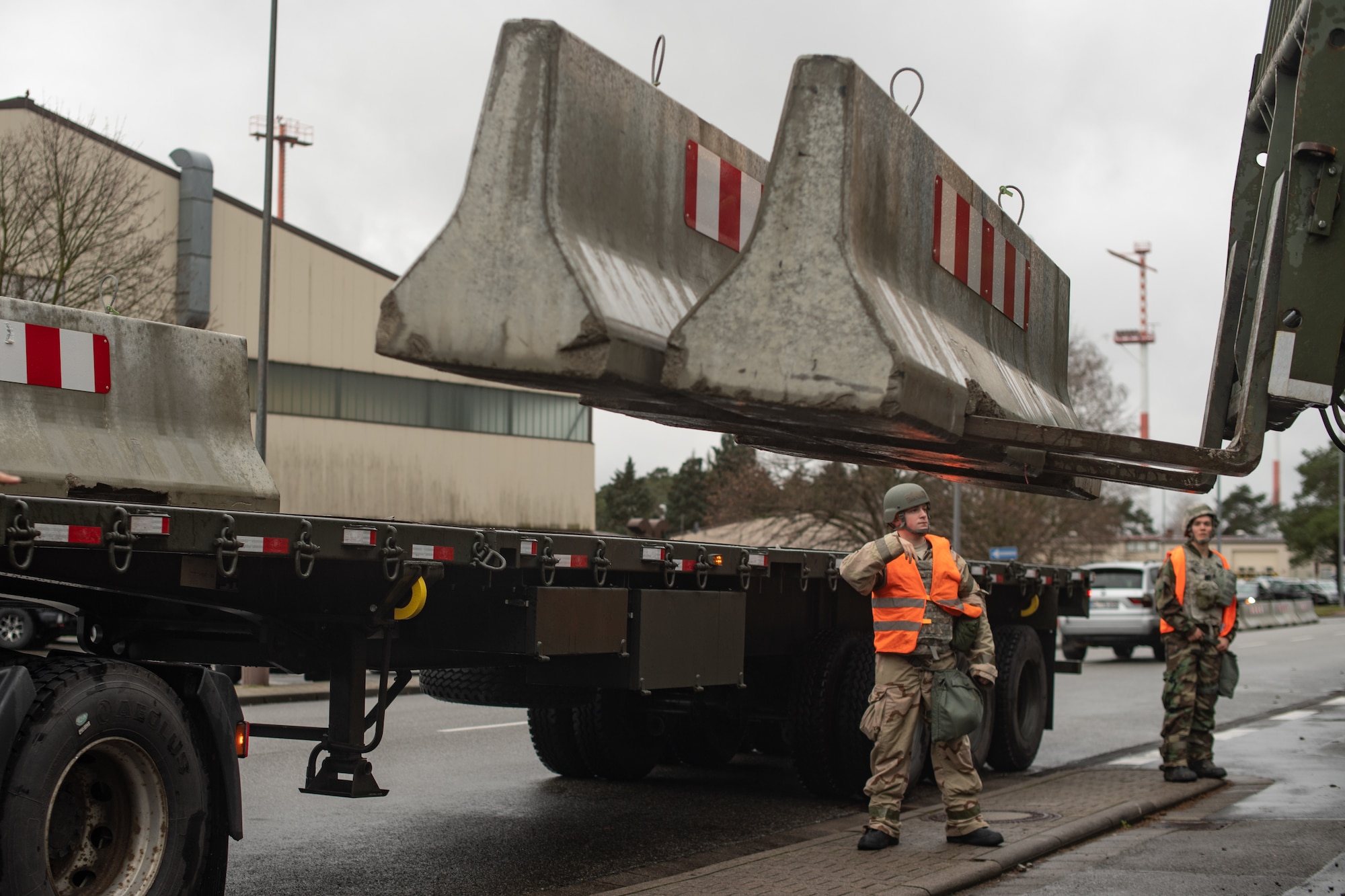U.S. Air Force Airman 1st Class Jack Carroll, 786th Civil Engineer Squadron pavement and construction equipment technician, directs a forklift operator moving concrete barriers during exercise Operation Varsity 19-04, Dec. 9, 2019. The Airmen set up the concrete barriers as part of force protection procedures in the exercise. (U.S. Air Force photo by Staff Sgt. Devin Boyer)