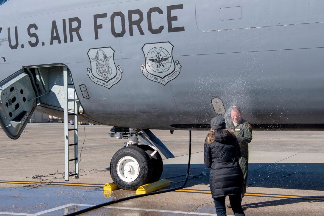 U.S. Air Force Lt. Col. Doug Miller is sprayed with champagne by his wife of 31 years, Connie Miller on the flightline on Seymour Johnson Air Force Base, North Carolina, Dec. 5, 2019.