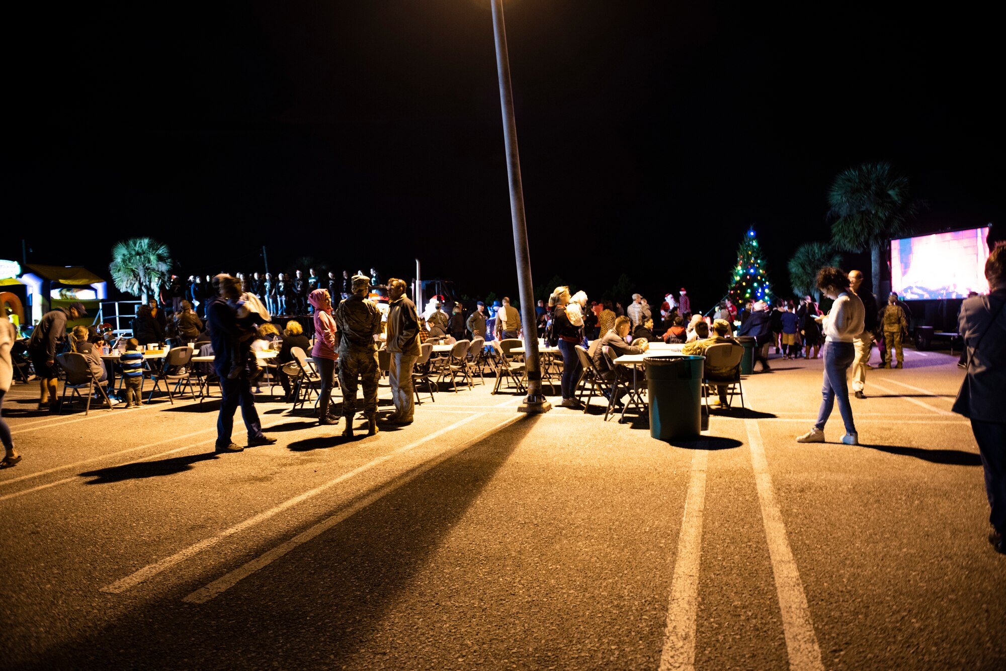 Service members, their spouses, dependents, local students, and retirees attend a holiday tree lighting ceremony hosted by the 325th Force Support Squadron at Tyndall Air Force Base, Florida, Dec. 6, 2019. The events was significant because it supported a sense of normalcy as the base continues to recover and rebuild after Hurricane Michael. (U.S. Air Force photo by Staff Sgt. Magen M. Reeves)