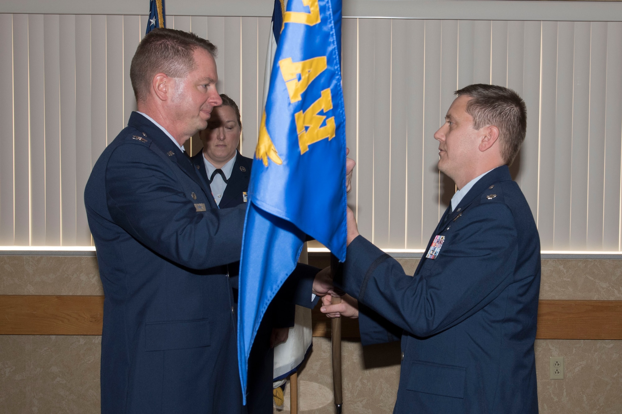 Col. Marty Timko, 167th Operations Group commander, passes the 167th Operations Support Squadron flag to Lt. Col. James Freid-Studlo during the 167 OSS change of command ceremony at the 167th Airlift Wing, Dec. 7, 2019.
