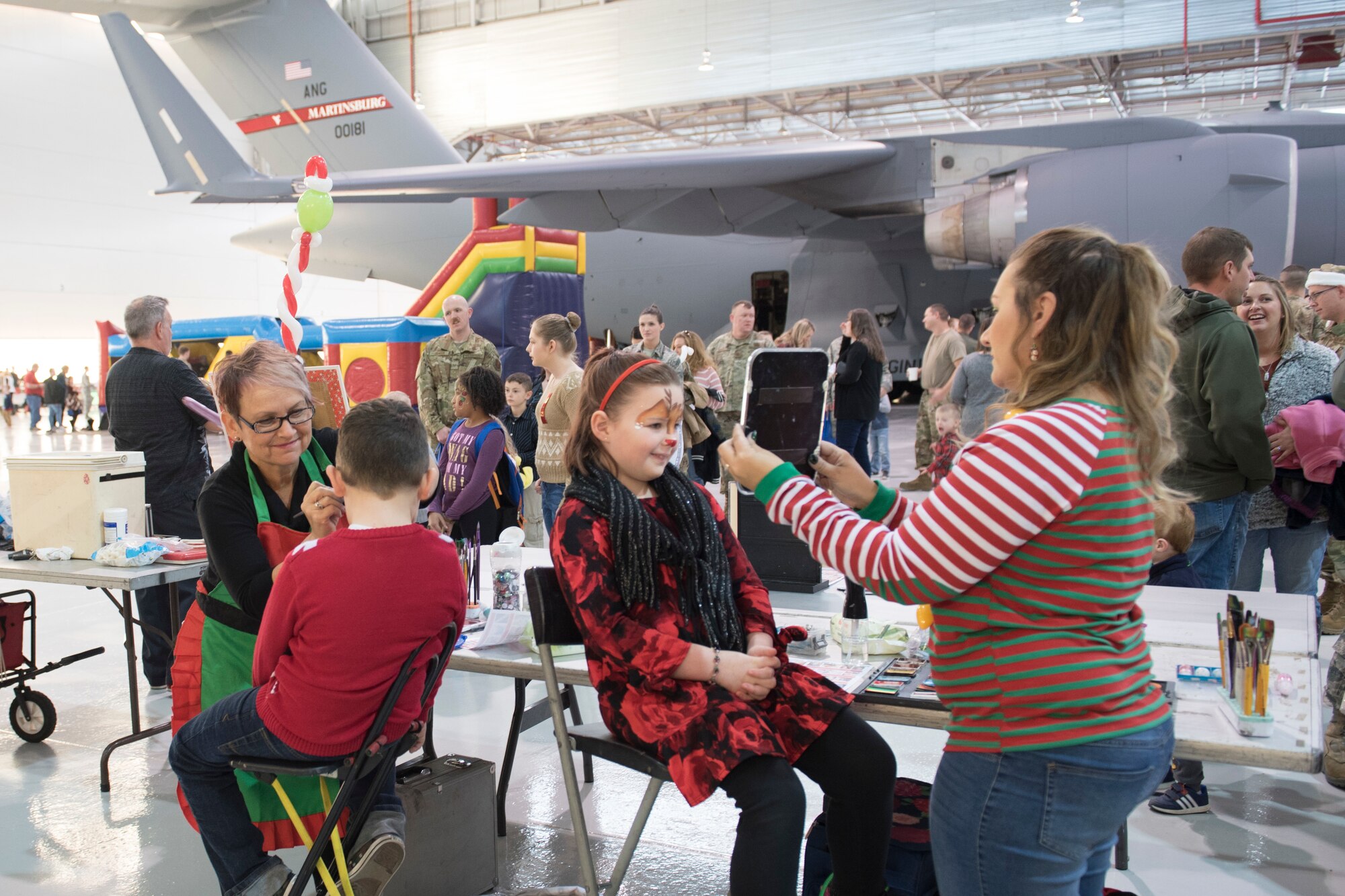 Children get their face painted at the 167th Airlift Wing family day event, Dec. 8, 2019.