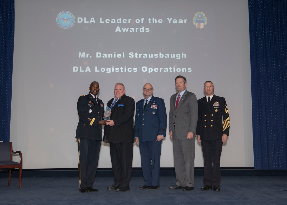 Five men pose with leader of the year award during the DLA 52nd Annual Employee Recognition Awards Ceremony Dec. 6.