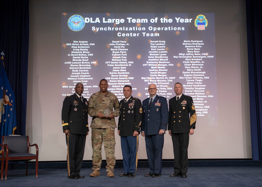 Five men pose with a group award during the Dec. 6 DLA Employee Recognition Awards Ceremony.