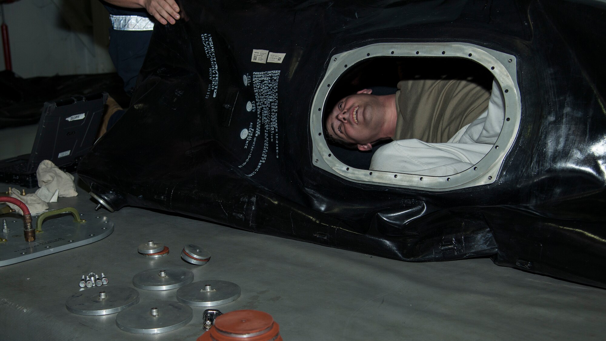 Sixth Maintenance Squadron (MXS) fuel systems Airmen crawl inside a fuel cell bladder at MacDill Air Force Base, Fla., Nov. 25, 2019.