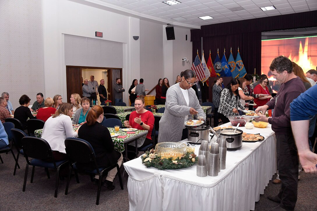 Employees make tough choices about which of the pies and cookies from the bake off to have with their breakfast.