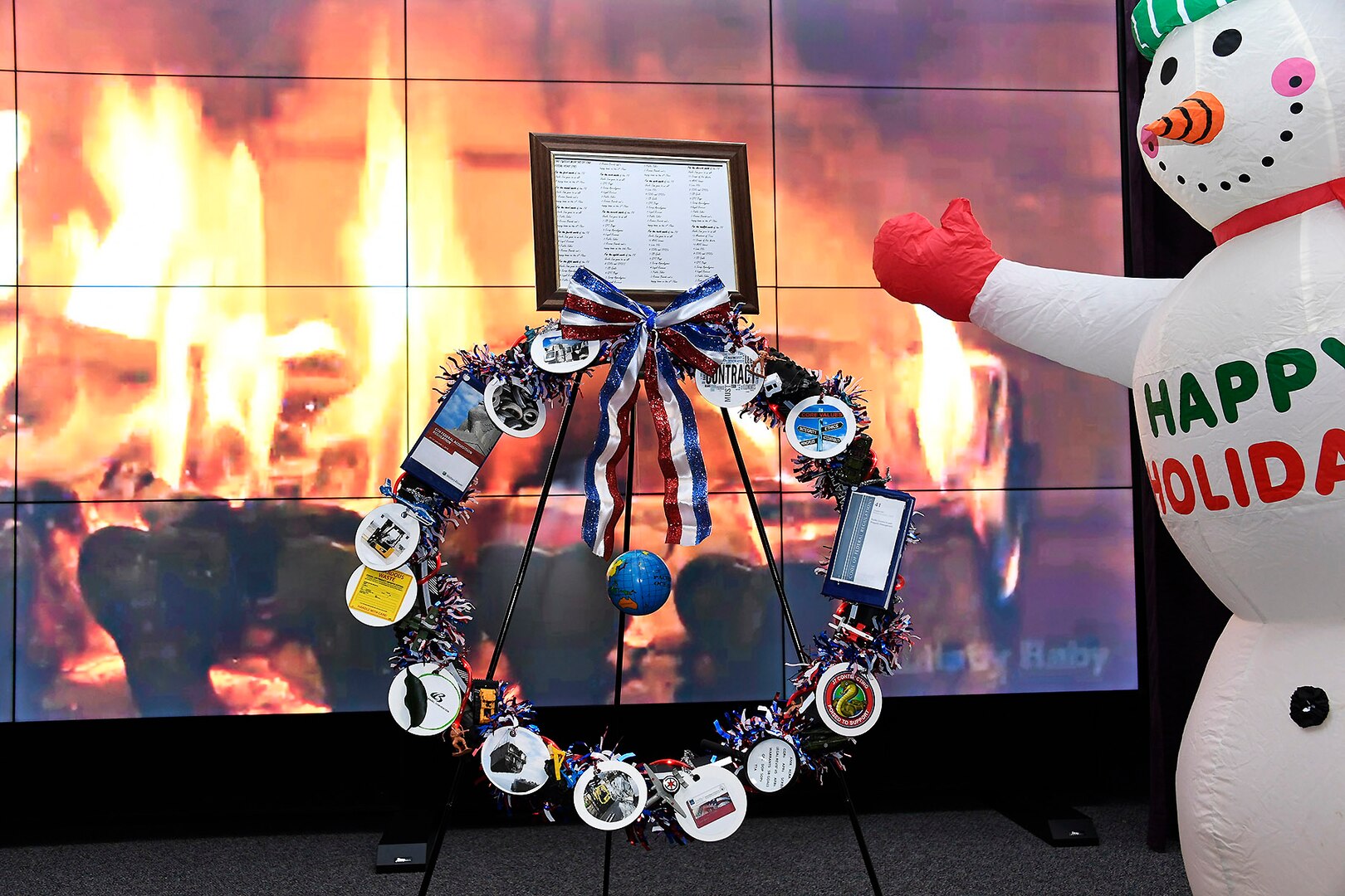 The Contracting Directorate’s entry in the wreath competition features the staff own carol, “The Twelve Months of the Fiscal Year,” as well as clever visuals about contracting.