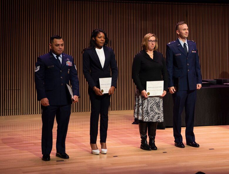 Finalists in the military leader category for the sixth annual Colorado Springs Mayor Young Leaders Award are recognized at the Ent Center for the Arts, Colorado Springs, Colorado, Dec. 9, 2019. From left, Tech. Sgt. John Camacho, 50th Security Forces Squadron lead investigator, Capt. Lauren Oglesby, 3rd Space Experimentation Squadron flight commander, and Maj. Louis Pagano, 21st Medical Squadron, director of psychological health, were three of the 30 finalist in six categories. Launched in 2015, the program celebrates the outstanding achievements of professionals aged 40 years and younger. This is the first time the military community in the Front Range were nominated. (U.S. Air Force photo by Staff Sgt. Matthew Coleman-Foster)