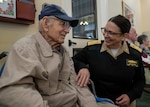 Rear Adm. Tina Davidson, commander of Navy Medicine Education, Training and Logistics Command, speaks with William “Bill” St. John during a visit to Poet’s Walk in San Antonio Dec. 6 about his experience during the attack on Pearl Harbor.